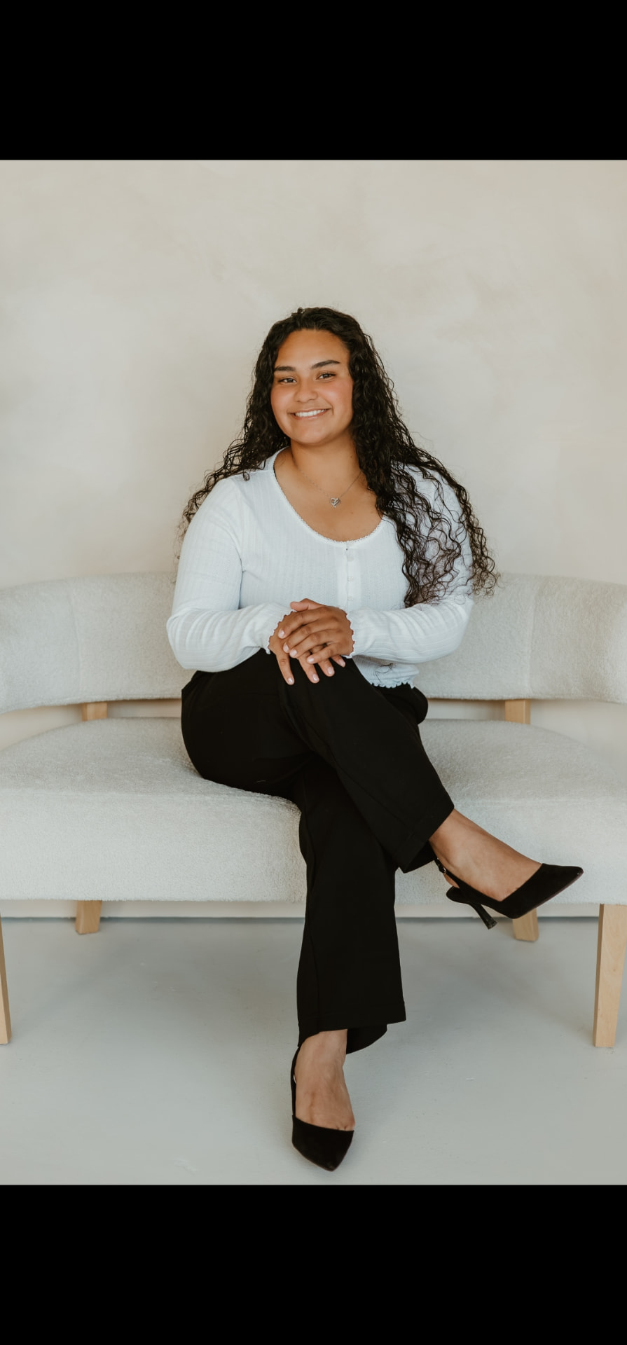 Realtor Annamarie Salazar seated, smiling, in a bright studio